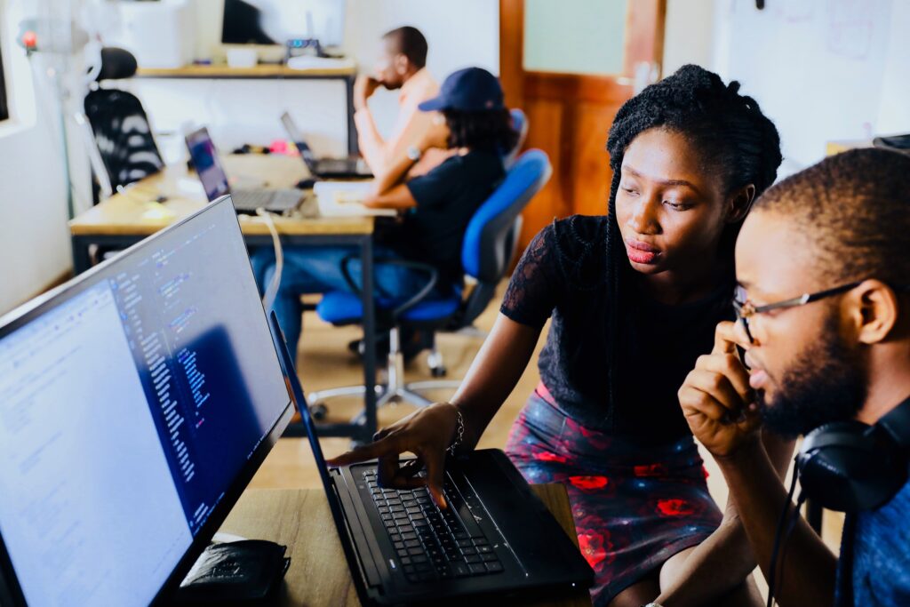 Two people working together on a computer